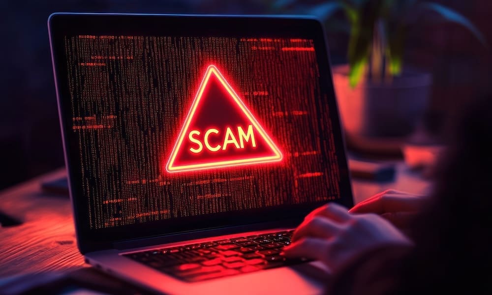 Preventing-Wire-Fraud - Laptop open to show a red scam alert
